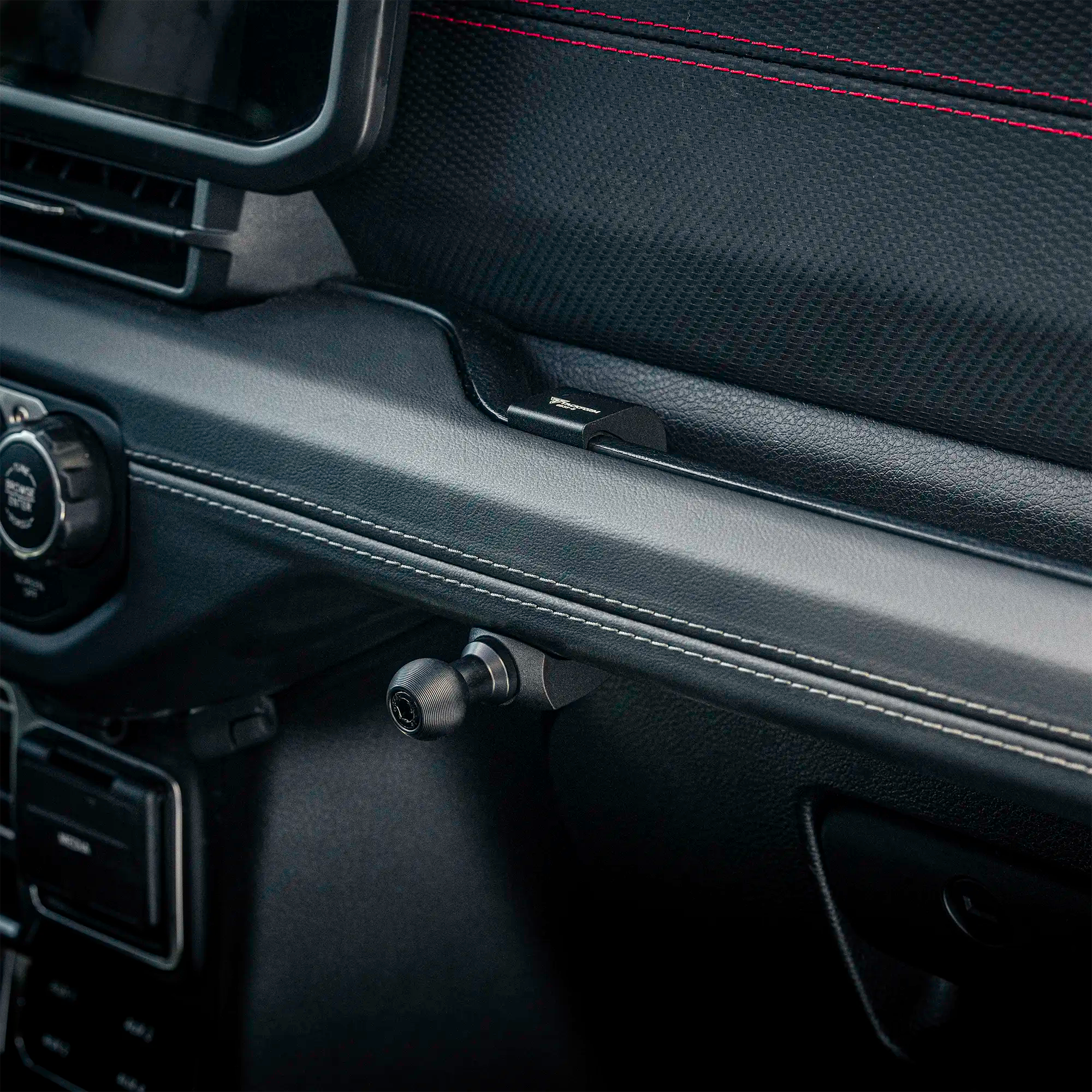 Jeep Grab Bar Mount installed on the passenger side grab bar of a 2024+ Jeep to mount phones, tablets, handheld radios, and more.