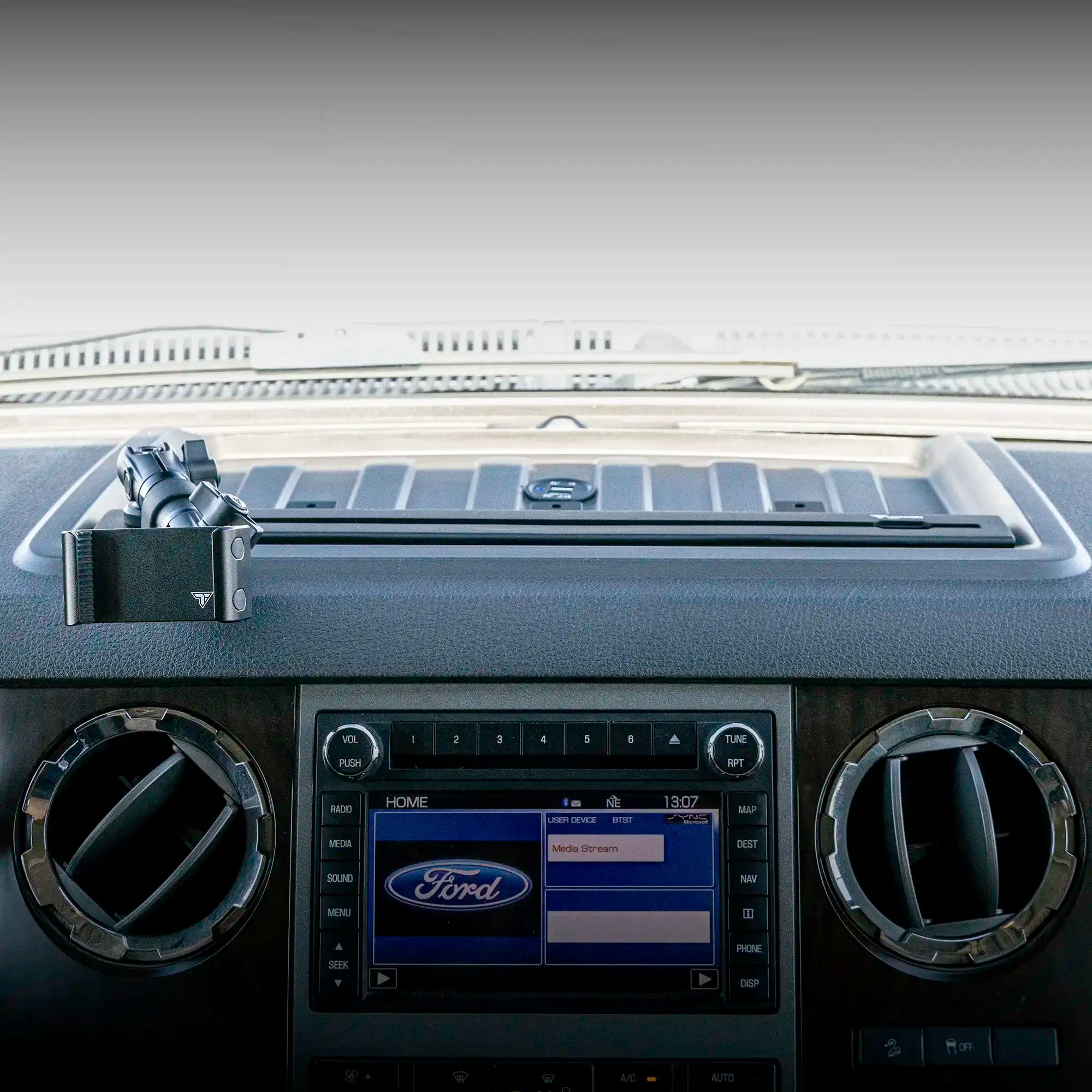 Dash bracket with universal phone mount installed in a Ford Super Duty